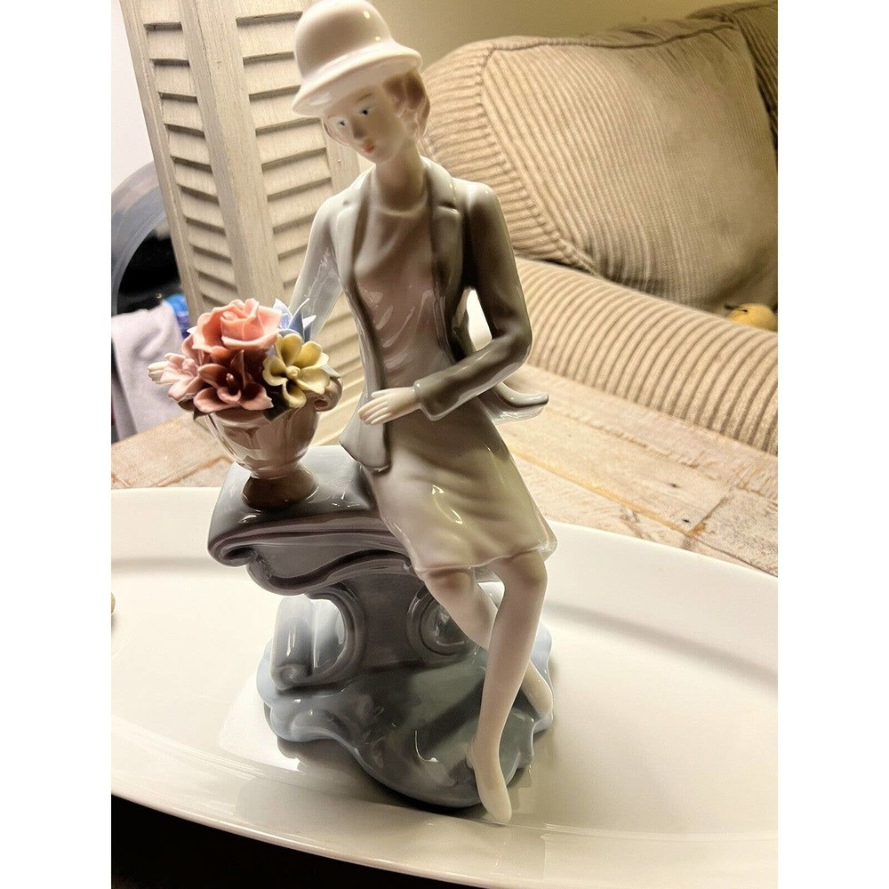 porcelaine lady on a bench with flowers